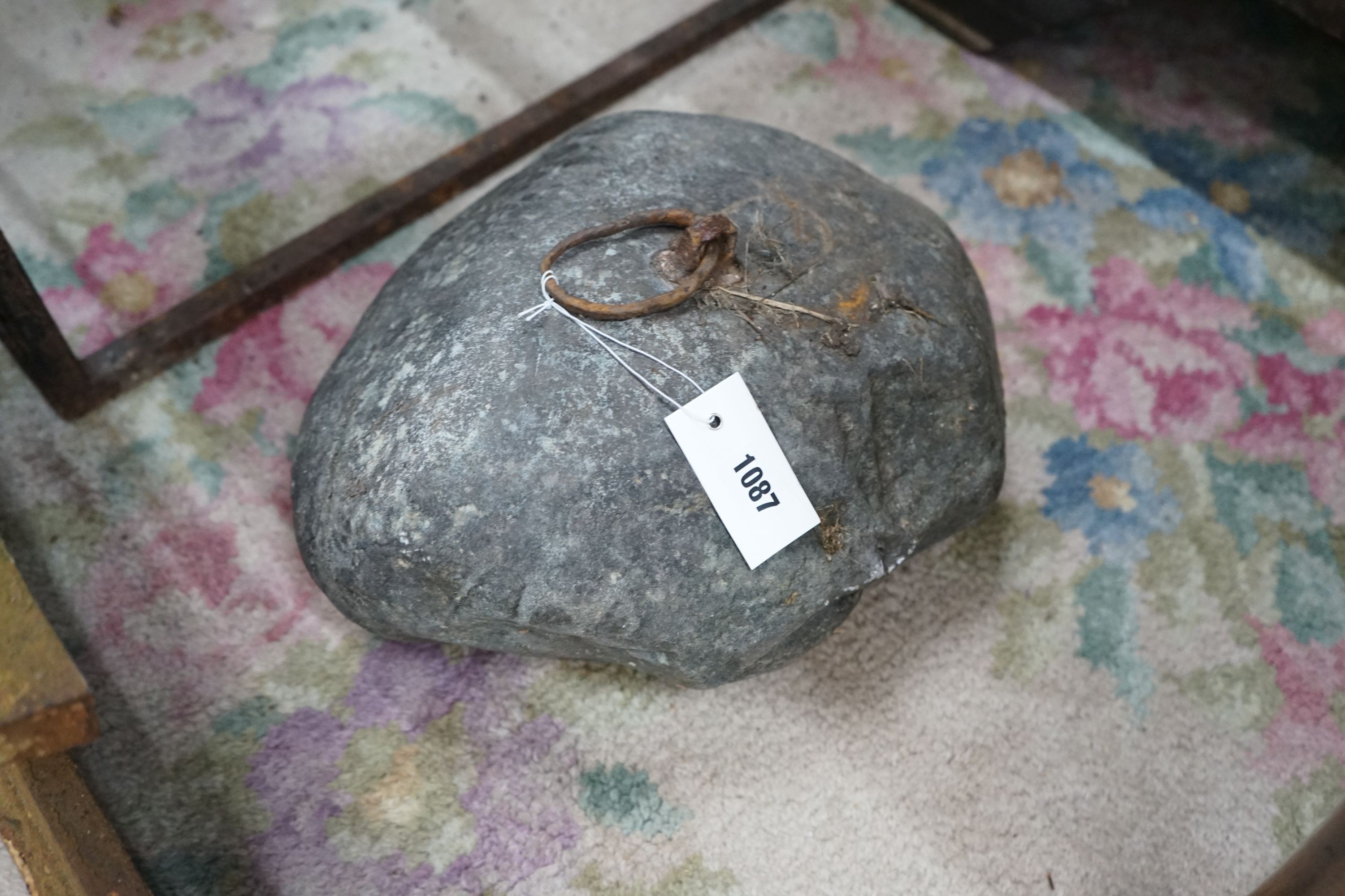 A vintage iron mounted tethering stone, width 36cm